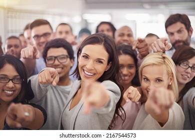 They want you on their team. Portrait of a group of smiling businesspeople pointing at the camera. - Shutterstock ID 2167544573