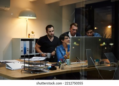 Theyre Driven To Succeed Together. Shot Of Employees Working In An Office At Night.