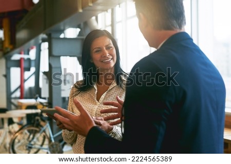 Theyre not afraid to go big with their ideas. Shot of two businesspeople having a discussion in an office.