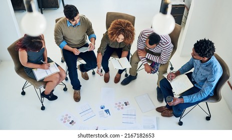 Theyre A Results Driven Team. Shot Of A Group Of Colleagues Having A Meeting In A Modern Office.