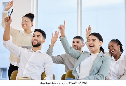 Theyve got an answer for everything. Cropped shot of a young and diverse group of businesspeople raising their hands during a seminar in the conference room.