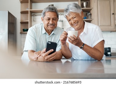 Theyve got the hang of technology. Shot of a senior couple using a phone together at home. - Powered by Shutterstock