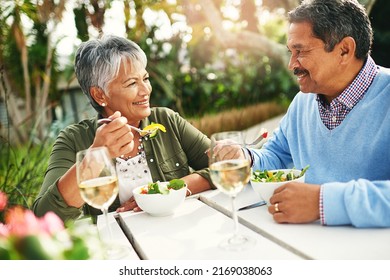 Theyve got a healthy marriage. Shot of a happy older couple enjoying a healthy lunch together outdoors. - Powered by Shutterstock