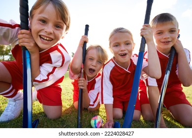 Theyve got strong team spirit. Portrait of happy children playing field hockey. - Powered by Shutterstock