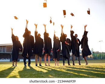 Theyve reached the end of their academic years. Shot of a group of university students throwing their hats in the air on graduation day.