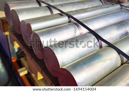 Thick aluminum rods. Aluminum warehouse. Remelting non-ferrous metals. Metallurgy. Manufacture of non-ferrous metal products. Foil production. Aluminum is in stock. Metallurgical enterprise.