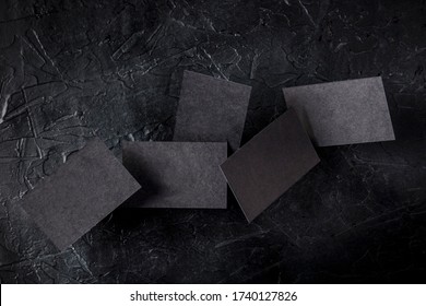 Thick Black Business Cards, Flying On A Dark Background, A Mock-up For A Creative Design Presentation