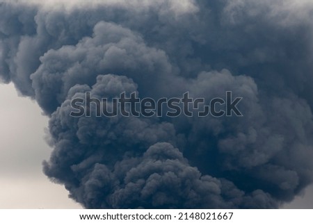 Thick black smoke covers the sky during the war between Ukraine and Russia. Disaster in Ukraine. Aggression war russia against Ukraine