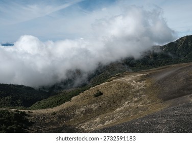 Thick Clouds Rolling Over Forested Slopes and Volcanic Patagonia Ridge
