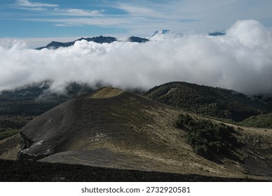 Thick Clouds Rolling Over Forested Slopes and Volcanic Patagonia Ridge