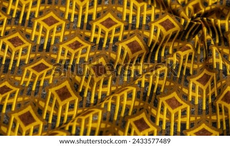 Thick cotton fabric with diamond print on yellow lines. On a gray background. Texture. Drawing. abstract geometric pattern with yellow, gray, brown diagonal, zigzag stripes, geometric background
