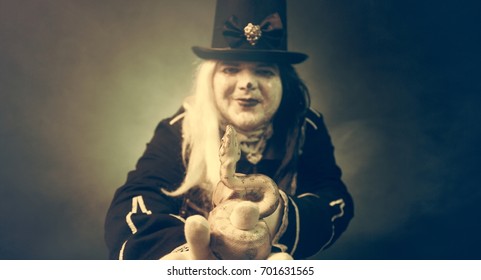 Thick crazy actor in white makeup with a snake.