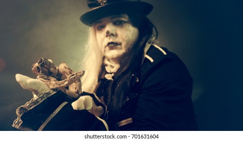 Thick crazy actor in white makeup with a snake.