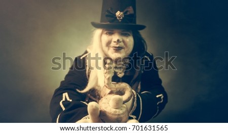 Thick crazy actor in white makeup with a snake.