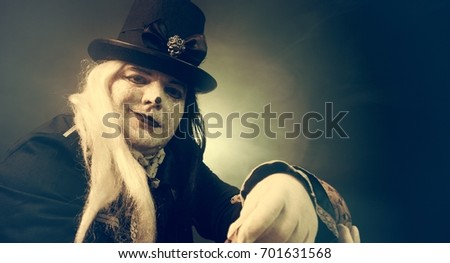 Thick crazy actor in white makeup with a snake.