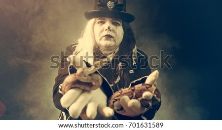 Thick crazy actor in white makeup with a snake.