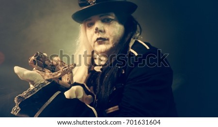 Thick crazy actor in white makeup with a snake.