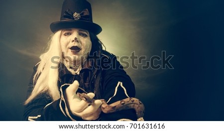 Thick crazy actor in white makeup with a snake.