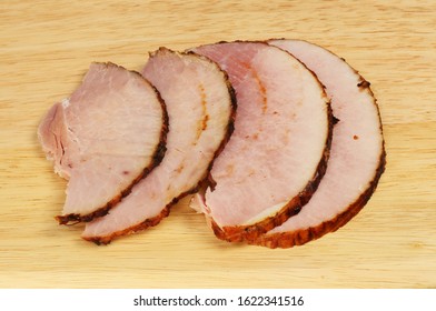 Thick Cut Ham Slices On A Wooden Chopping Board