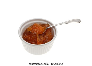 Thick Cut Marmalade In A Ramekin With A Spoon Isolated Against White