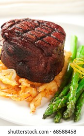 Thick Filet Mignon Served With Crispy Onions And Asparagus