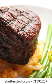 Thick Filet Mignon Served With Crispy Onions And Asparagus