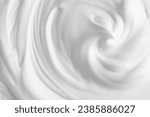 Thick foam swirl texture. White cream, mousse, cleanser, shampoo, shaving foam. Foamy cosmetic product closeup