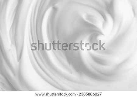 Thick foam swirl texture. White cream, mousse, cleanser, shampoo, shaving foam. Foamy cosmetic product closeup