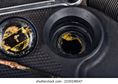 The Thick, Greasy Yellow Motor Oil Under Oil Cap As Signs And Symptom Of A Blown Head Gasket. Broken A Car