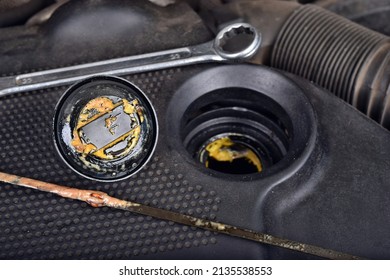 The Thick, Greasy Yellow Motor Oil Under Oil Cap As Signs And Symptom Of A Blown Head Gasket. Broken A Car