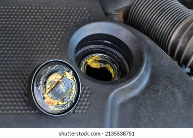 The Thick, Greasy Yellow Motor Oil Under Oil Cap As Signs And Symptom Of A Blown Head Gasket. Broken A Car