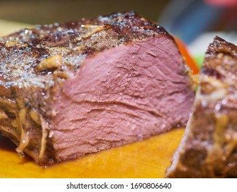 Thick Juicy Piece Of Beef Meat Steak Filet Mignon In Spices Pepper Garlic Rosemary Sliced In Two Pieces On A Wooden Board Closeup Macro With Bokeh