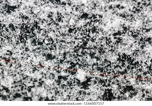 thick layer of snow\
and snowflakes adhered to the rear window of the car. Photo with a\
shallow depth of field