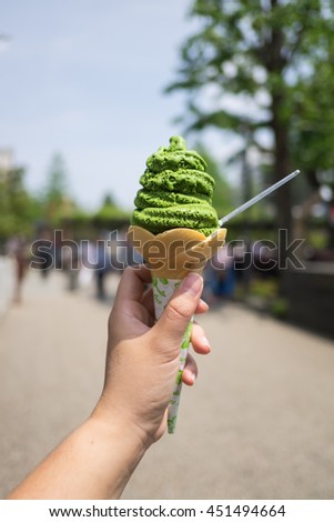 Thick matcha green tea soft serve ice cream in cone