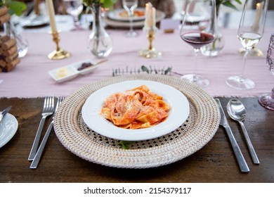 Thick Noodle Red Sauce Pasta On Wicker Charger Plate