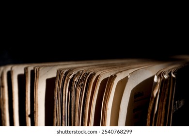 A thick old book standing in a low light place - Powered by Shutterstock