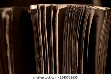 A thick old book standing in a low light place - Powered by Shutterstock