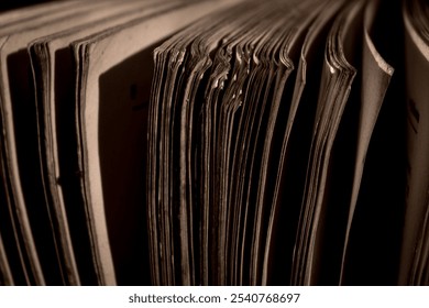 A thick old book standing in a low light place - Powered by Shutterstock