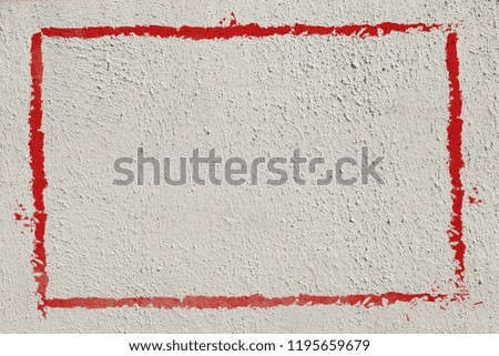 Thick red graffiti painted frame border on whitewashed concrete wall with copy space for writing