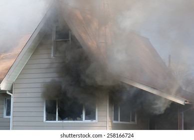 Thick Smoke Engulfs A Home, Foreshadowing The Blazing Destruction To Come.