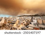 Thick smoke from wildfires in Varvanas and Grammatiko regions engulfs the sky over Athens, Greece, creating a dramatic and ominous scene above the city