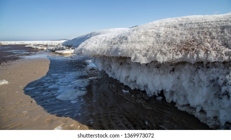 Thick and solid blocks of ice at the White sea in the early spring close up