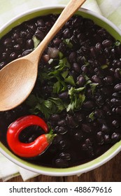 Thick Soup Of Black Bean With Chilli Peppers Close Up In A Bowl On The Table. Vertical View From Above
