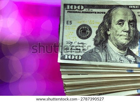 Thick stack of hundreddollar bills piled against neon pink backdrop, heavy bundle suggests bankroll or cash reserve, gritty texture contrasts with glamorous lighting of entertainment venue.