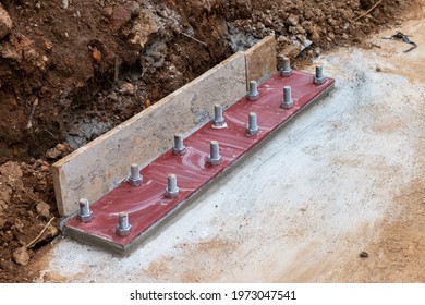 A Thick Steel Base Plate Is Attached By A Large Nut To The Cement Floor. Steel Column Base For The Stability Of Steel Building Structure