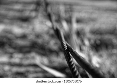 Thick Steel Rope Close Up. Bridge Fence Element. Detailed View. The Surface Of The Steel Cable Is Covered With Rust..