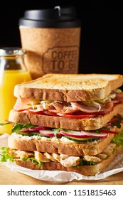 Thick Tasty Fresh Sandwich With Ham And Vegetables Against Cup Of Coffee