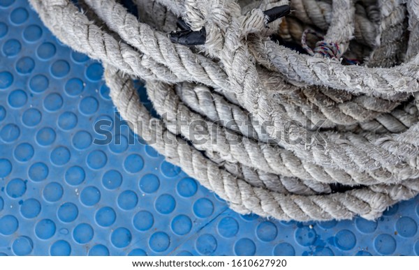 Thick White\
Nautical Rope on a Blue Deck of a\
Ship