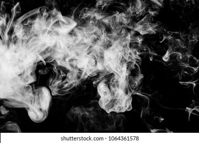 Thick White Smoke On A Black Isolated Background. Background From The Smoke Of Vape