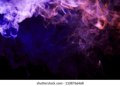 Thickpink and purple smoke on a black isolated background. Background from the smoke of vape